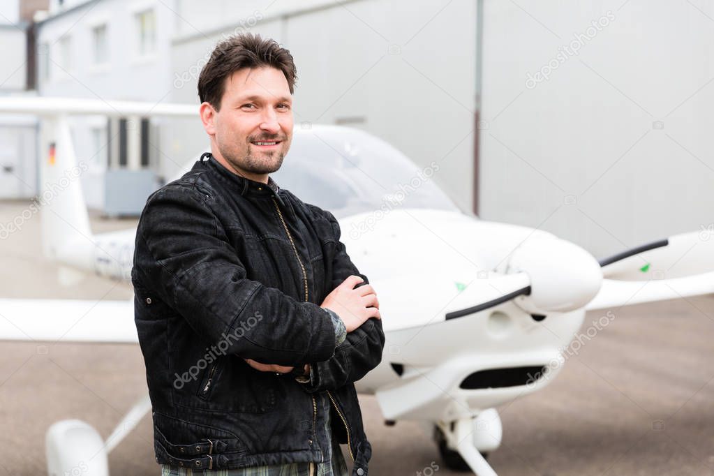 Sport pilot standing in front of his plane