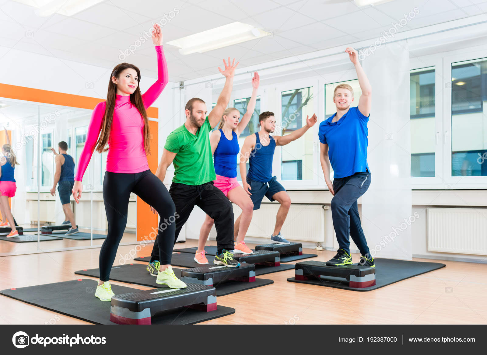 Aerobic Exercise In Gym Men And Women Doing Step-aerobics At Gym - Main Image
