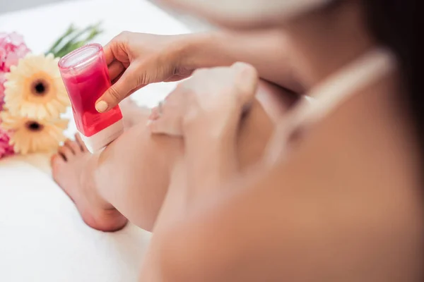 Hand of a young woman using a modern recharchable roll-on waxer — Stock Photo, Image