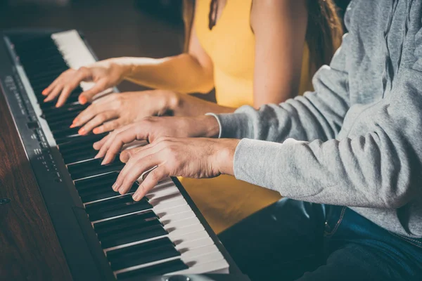 Piano players playing together four-handed — Stock Photo, Image