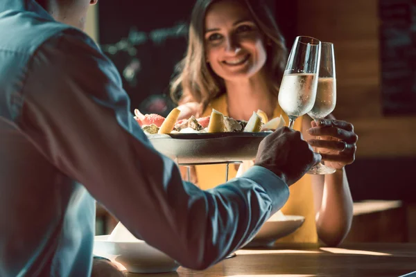 Happy couple in love toasting with champagne during romantic dinner — Stock Photo, Image