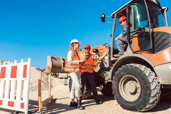 Bauingenieur und Arbeiter diskutieren über Straßenbaustelle — Stockfoto