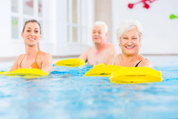 Senior and young people in water gymnastics — Stock Photo, Image