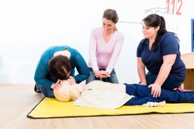 Group of women in first aid course clipart