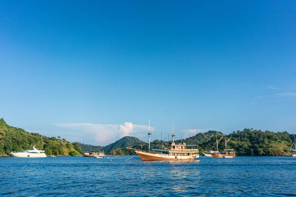 Sailing boats moored along the shore in a sunny day of summer in Indonesia