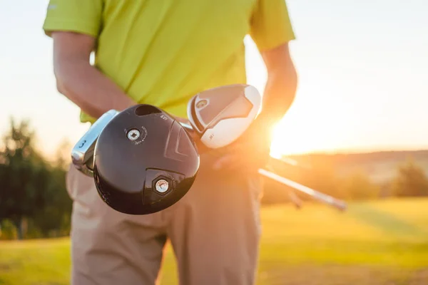 Primer plano de las manos de un jugador profesional masculino que sostiene palos de golf — Foto de Stock