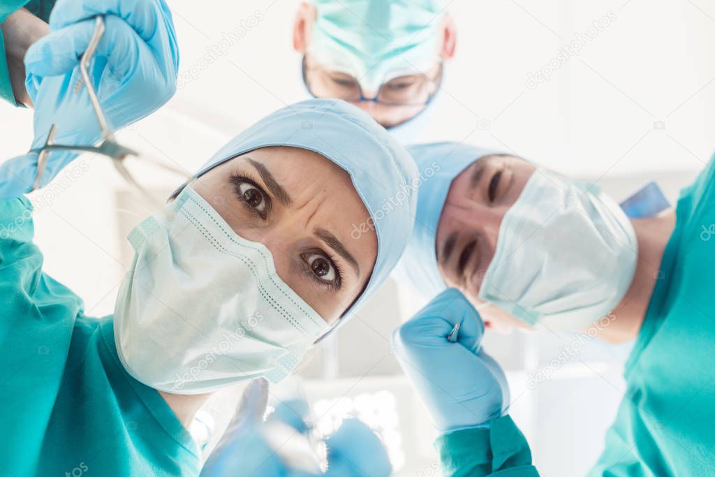 Mad surgeon doctors looking at patient POV