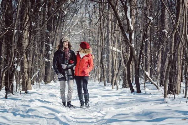 Женщина и мужчина наслаждаются зимой в снегу — стоковое фото