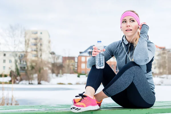 Mujer descansando de trotar o practicar deporte en el día de invierno —  Fotos de Stock