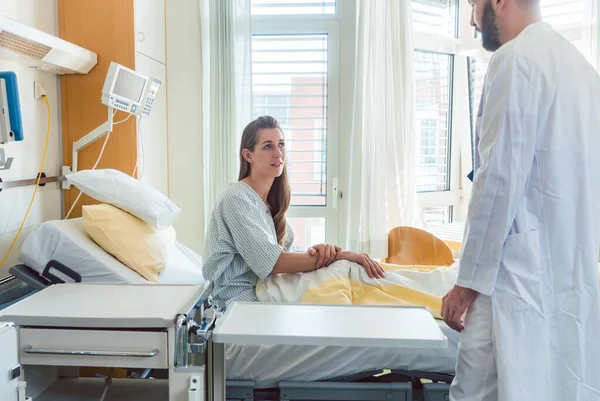 Patienten väntar i sjukhus säng för läkare att se henne — Stockfoto