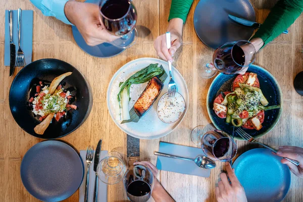 Top pandangan pada orang, minuman, dan makanan di restoran mewah — Stok Foto