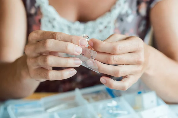 Woman making her own jewelry as a hobby — 스톡 사진