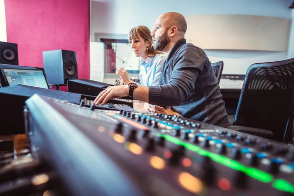 Sound engineer and singer or musician discussing the mix — Stock Photo, Image