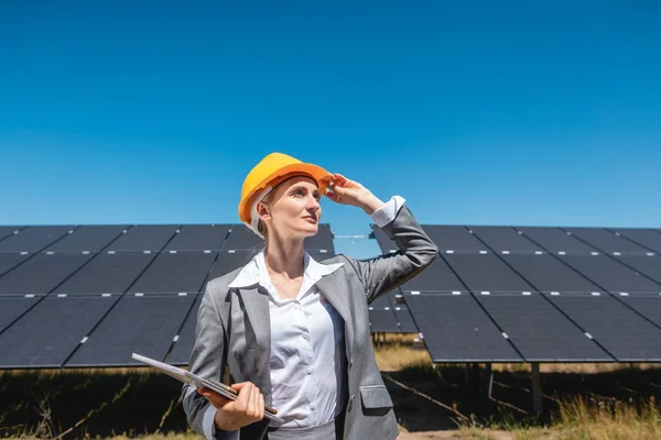 Ділова жінка або інвестор, що перевіряє свою сонячну ферму — стокове фото