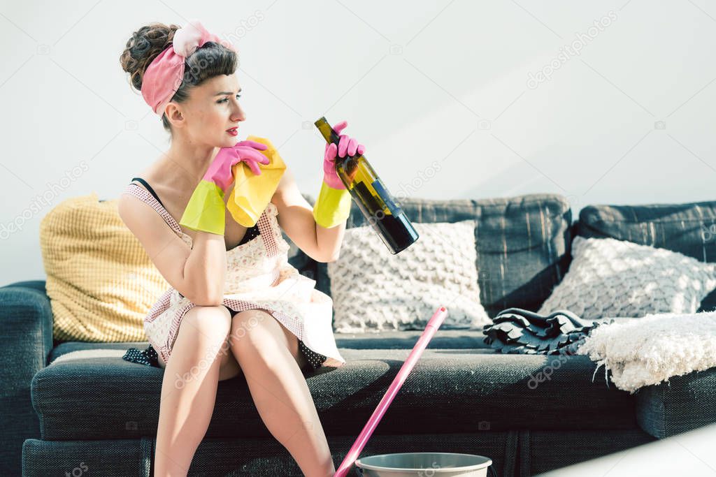 Unhappy housewife drowning her frustration with alcohol
