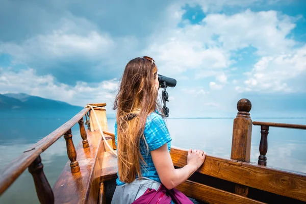 Woman on a boat with binocular watching birds — 스톡 사진