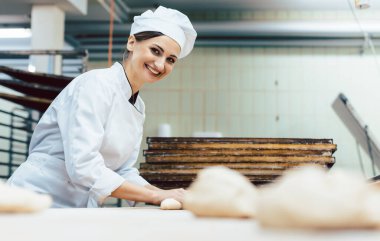Baker with freshly baked bread in the bakery