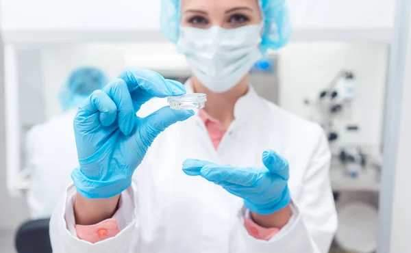 Scientist in biolab showing vaccine for a disease — Stok fotoğraf