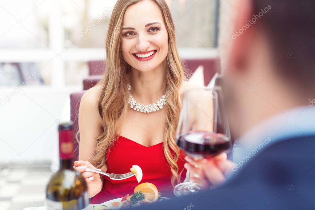 Couple toasting with red wine in romantic restaurant