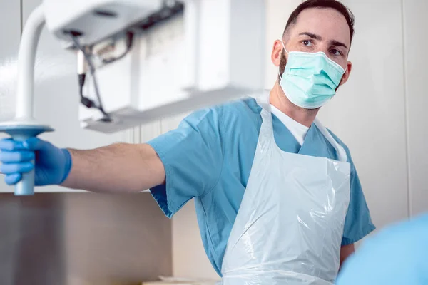 Internal specialist doctor during endoscopy procedure adjusting screen — Stock Photo, Image