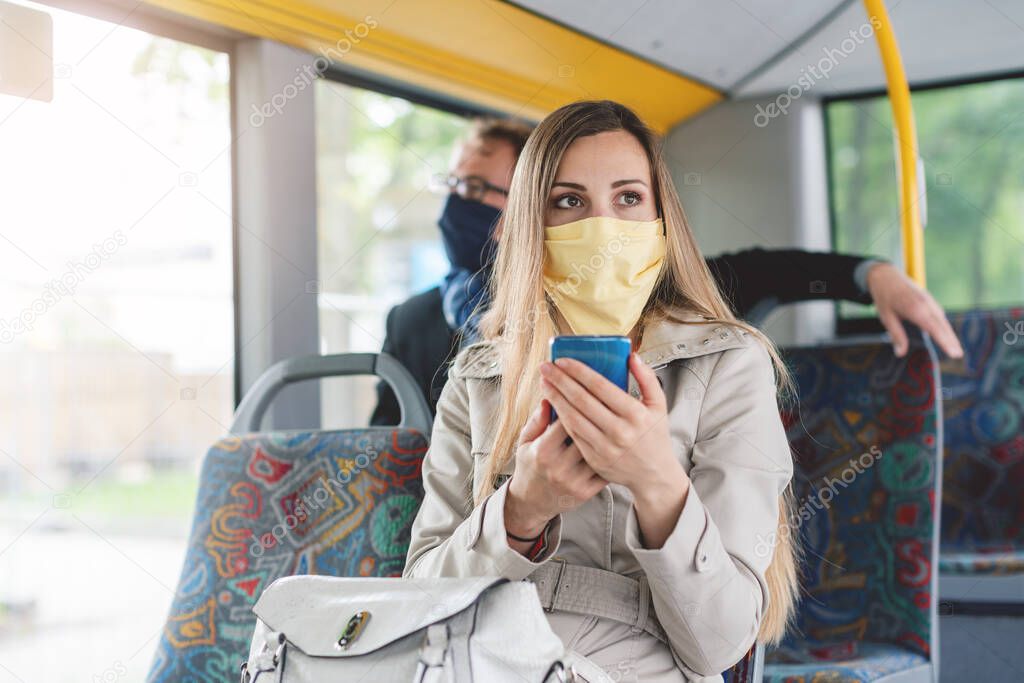 People wearing masks in the bus using public transport