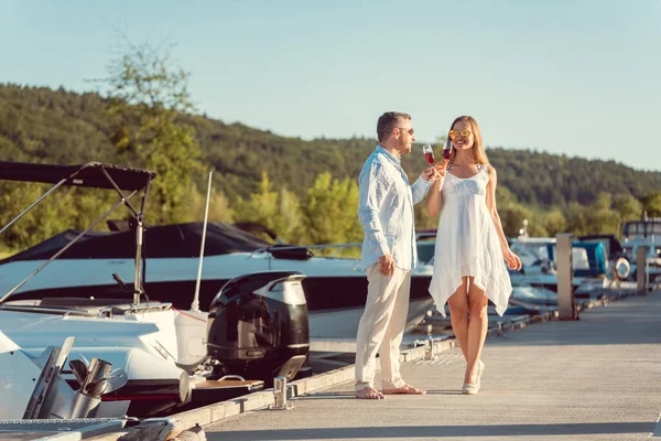 Couple walking between the boats on a river port — 스톡 사진