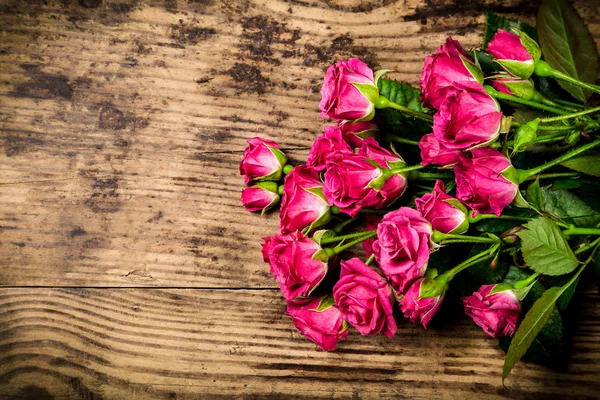 Λίγο ροζ τριαντάφυλλα σε φόντο ξύλινη — Φωτογραφία Αρχείου