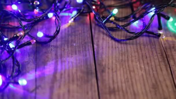 Christmas lights on wooden background — Stock Video