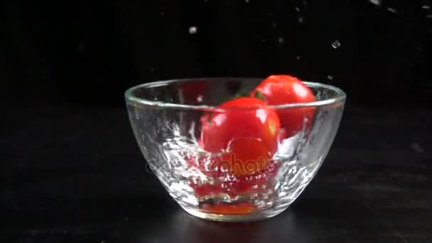 Tomates cereja caindo em tigela de vidro, câmera lenta 250 fps — Vídeo de Stock