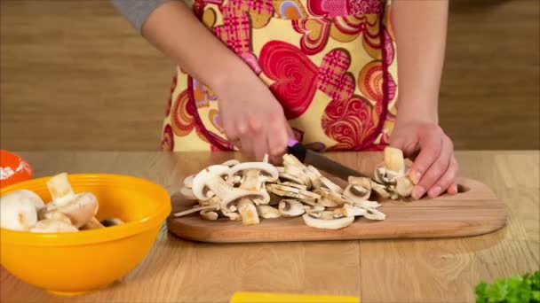 Крупним планом дівчата руки різання грибів на кухні — стокове відео