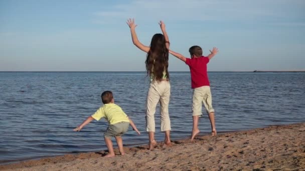 Group of three kids jumping at the beach in Egypt resort, slow m — Stock Video