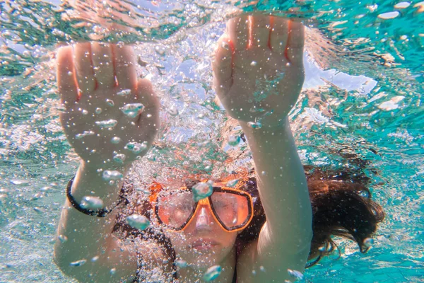 Chica en buceo máscara de natación en el mar cerca de los arrecifes de coral —  Fotos de Stock