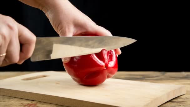 Gesneden rode paprika op houten snijplank — Stockvideo