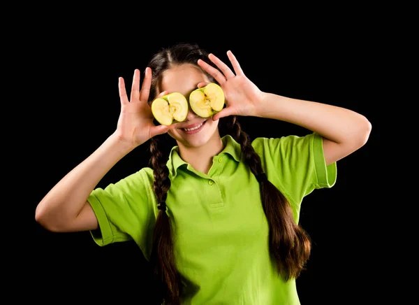 Smiling girl with green apple on eyes — Stock Photo, Image