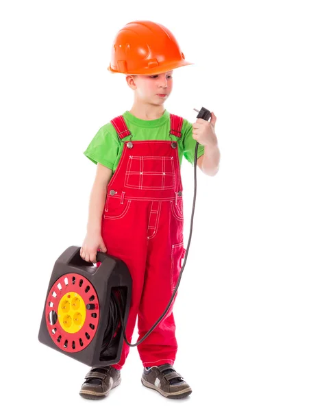 Little builder in helmet with electrical extension cord — Stock Photo, Image