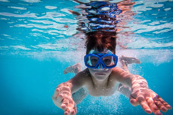 Мальчик в маске ныряет в бассейн — стоковое фото