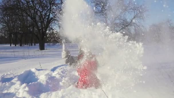 Criança feliz joga a neve no parque de inverno — Vídeo de Stock