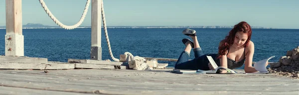 Studying by the sea 스톡 사진