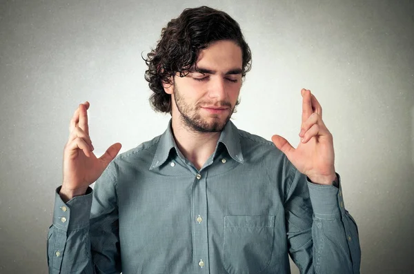 Happy man crossing his fingers — Stock Photo, Image