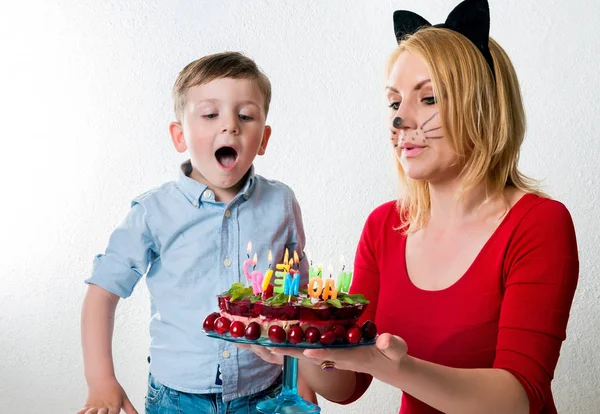 Niño con mamá y el pastel de cumpleaños — Foto de Stock