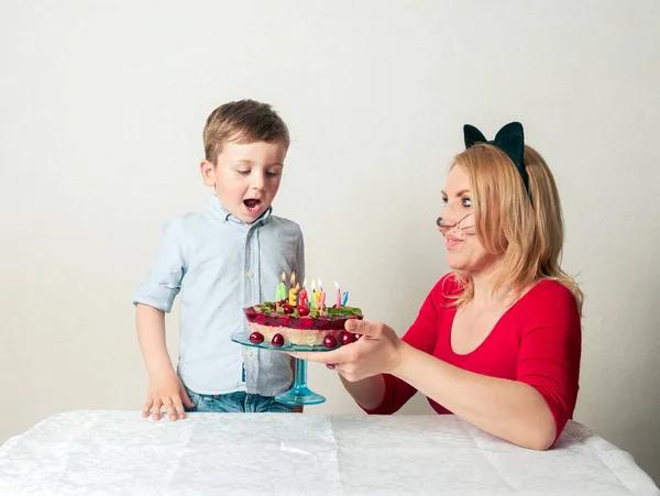 Mały chłopiec z mamą i tort urodzinowy — Zdjęcie stockowe