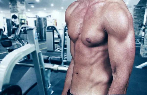 Strong man in the gym — Stock Photo, Image