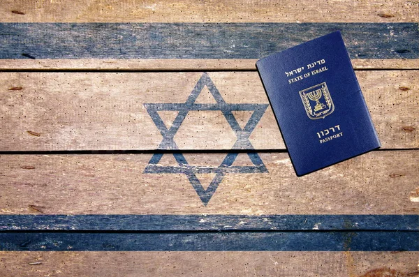 Israel passport on the table and flag