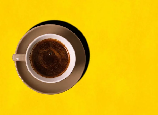 Cup of coffee on the yellow background — Stock Photo, Image