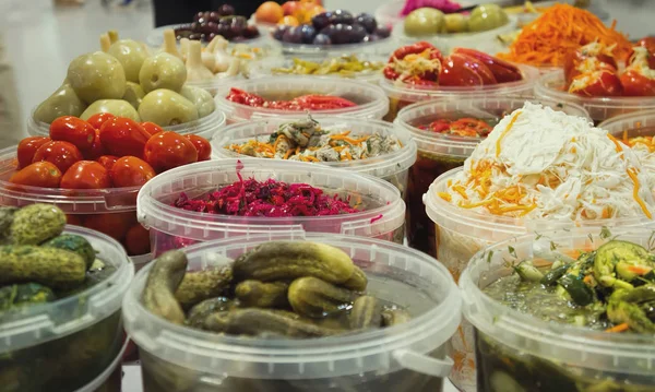 Plastic containers with pickled vegetables. Stock Image