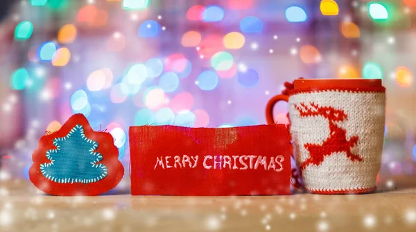 Cup with Christmas ornament and the words "merry Christmas" on a — Stock Photo, Image