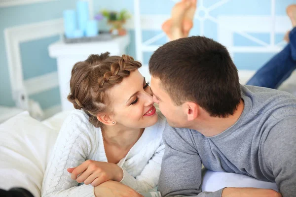 Happy couple on the sofa bed in the living room. — Stock Photo, Image