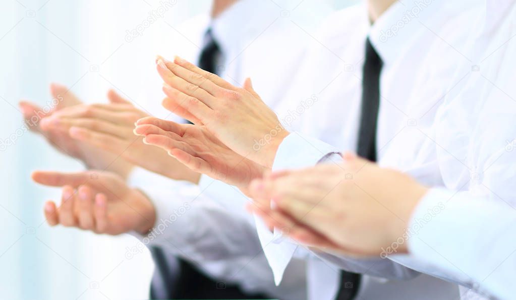 Happy business group of people clapping hands during a meeting 