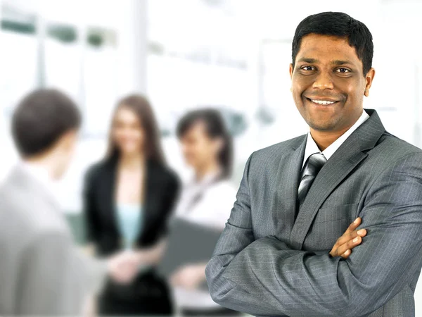 Happy black business man with people in the background — Stock Photo, Image
