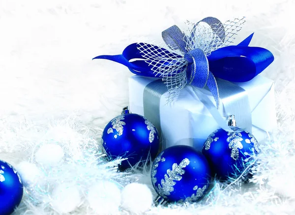 Christmas. holiday gift in a beautiful package and blue glass — Stock Photo, Image